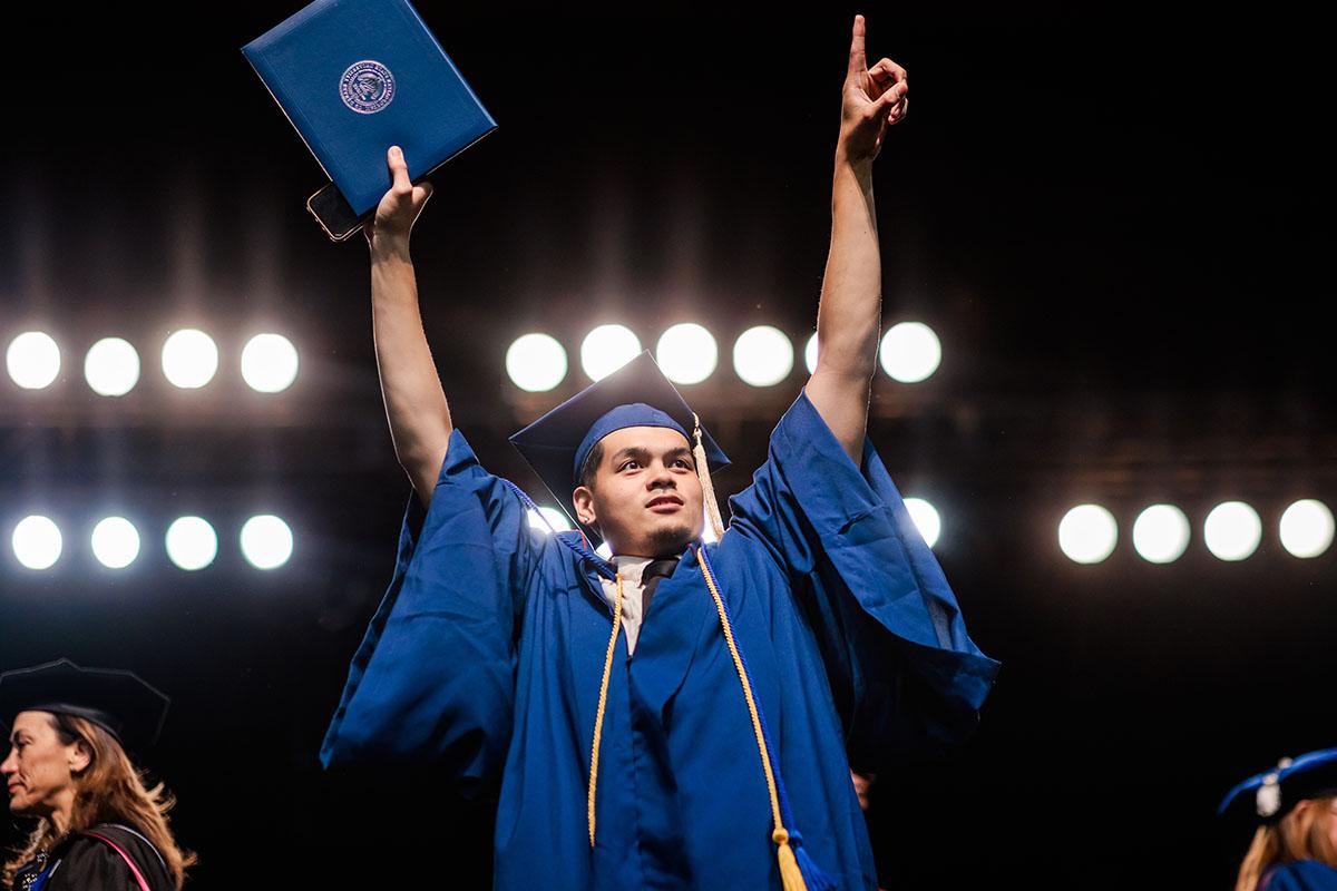 MSU Denver graduate proudly receives his diploma.